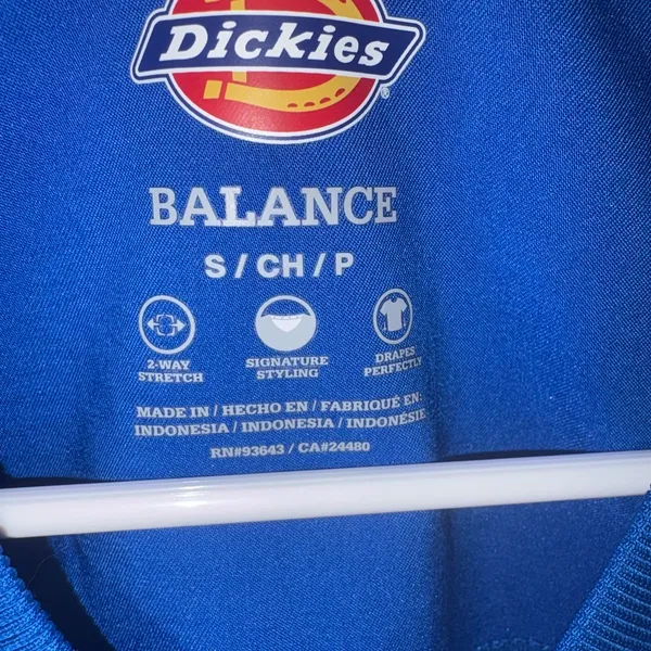 blue Dickies Balance scrub top features a v-neckline and a functional chest pocket. - Image 2