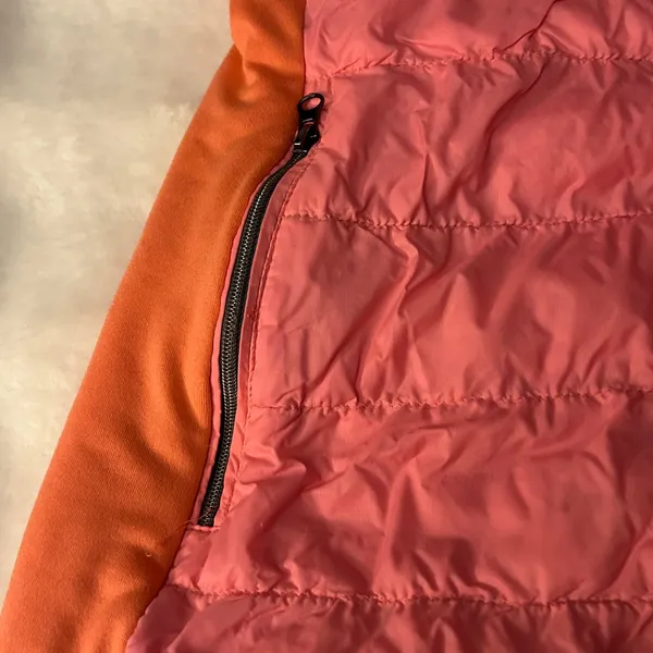 a Tangerine women's puffer vest in pink with orange side panels. Size large - Image 2