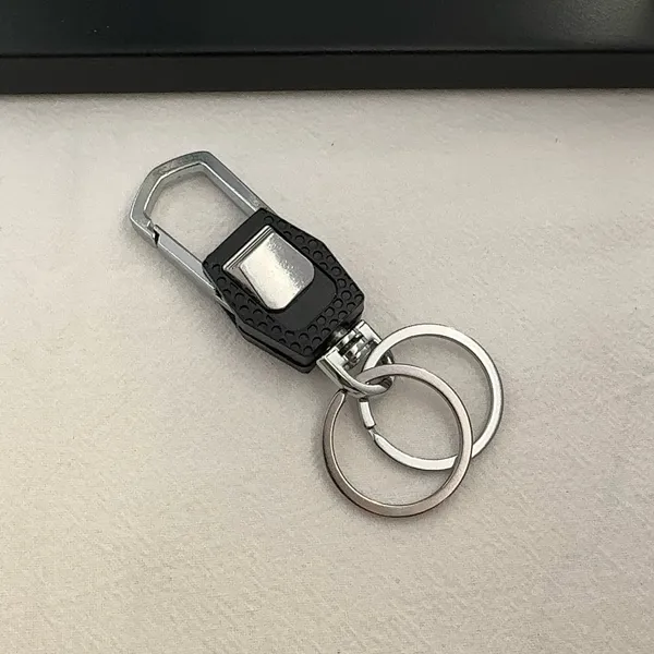 Practical carabiner keychain designed for both men and women for everyday carrying needs. Comes with double key rings, allowing you to classify and organize different keys separately. This keychain is 2.5 inches in length and 0.9 inches in width, compact and portable to carry around. Suitable for car keys, home keys, small gadgets, backpacks and handbags for convenient hanging. Simple versatile style matches various scenarios, a nice daily accessory and casual small gift. - Image 2
