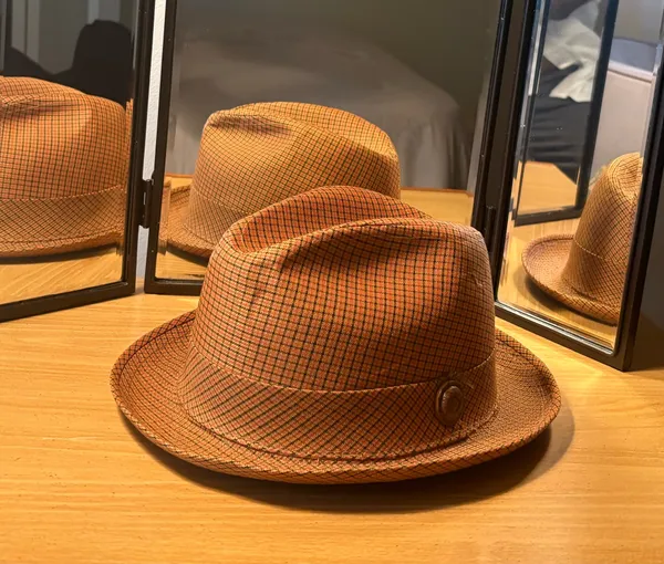 This Men’s Top Hat in size Medium is a stylish and lightweight accessory perfect for casual occasions during the winter, fall, and spring seasons. Made of wool felt in a solid brown color, this handmade top hat exudes a classic and sophisticated look. With its unique style and comfortable fit, this top hat is sure to add a touch of elegance to any ensemble. - Image 2