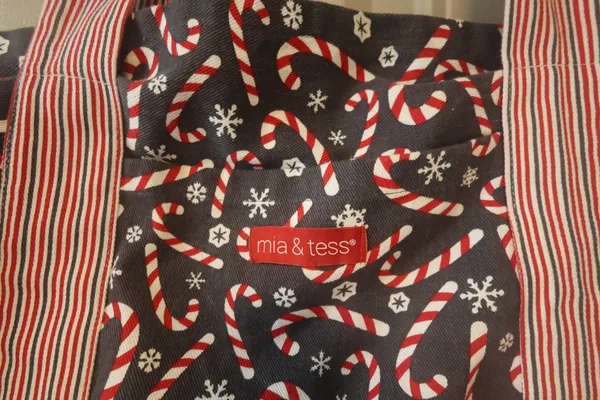 Mia and Tess candy cane and snowflake Christmas tote in black, red and white. - Image 4