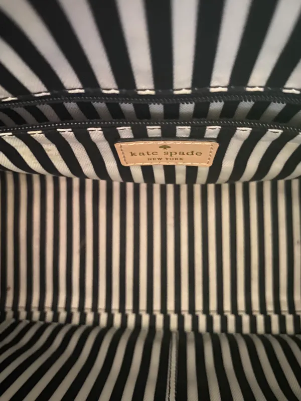 Kate Spade NEW YORK-MINT MOJITO PIPPA PARNELL STREET LEATHER SATCHEL Perfect spring bag, mint green white tan handle and crossbody strap, top zip closure, stripe print interior, inside zip pocket, inside two open pockets, amazing condition, there are two call outs, a small smudge on the bottom of the bag and a small smudge on one corner, please see the last two pictures **This bag is preowned and is being sold as is** - Image 11