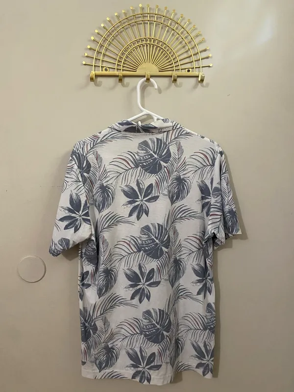 TravisMathew White Polo with Blue Tropical Leaf Print - Image 2
