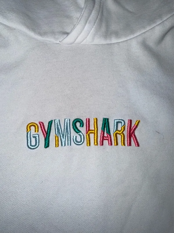 Gymshark Embroidered Logo Pullover Hoodie in White with Multicolored Text - Image 2