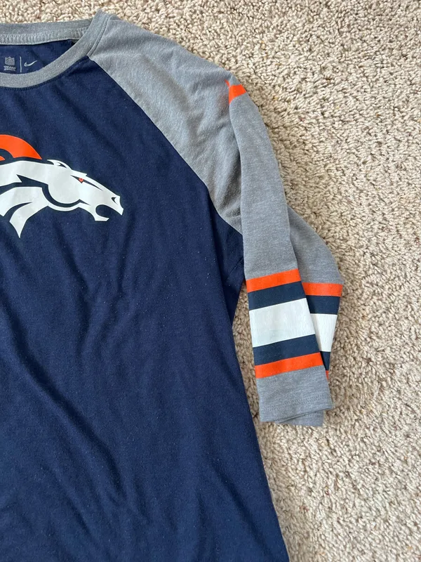Denver Broncos logo on the chest. Navy body with gray raglan sleeves. Orange and white stripe accents on sleeves. Lightweight fan tee for game days. Nike. Size XL - Image 3