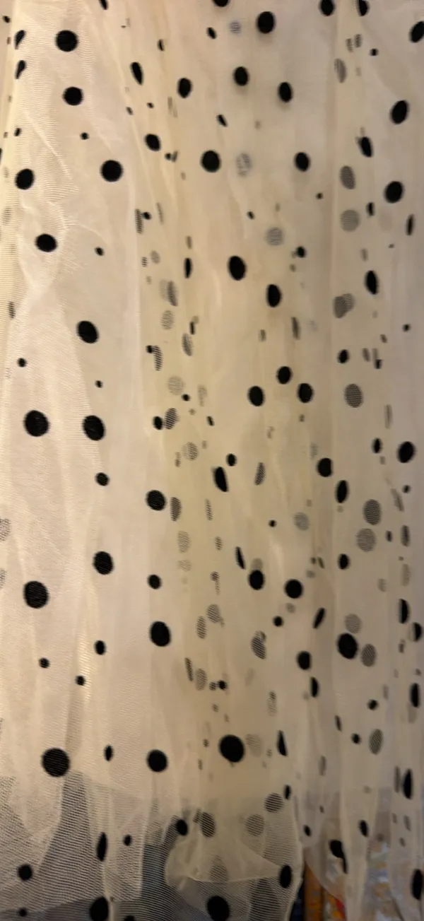 strapless tulle mini dress featuring a cream or light beige mesh fabric adorned with classic black polka dots. It is designed with a heavily ruched, pleated sweetheart bodice, a defined cinched waistband, and a voluminous tiered ruffled skirt. - Image 6