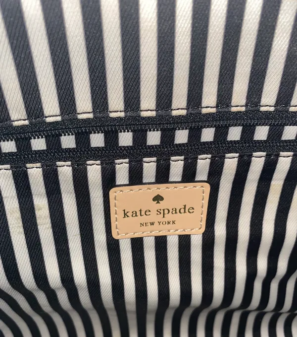 Kate Spade NEW YORK-MINT MOJITO PIPPA PARNELL STREET LEATHER SATCHEL Perfect spring bag, mint green white tan handle and crossbody strap, top zip closure, stripe print interior, inside zip pocket, inside two open pockets, amazing condition, there are two call outs, a small smudge on the bottom of the bag and a small smudge on one corner, please see the last two pictures **This bag is preowned and is being sold as is** - Image 9