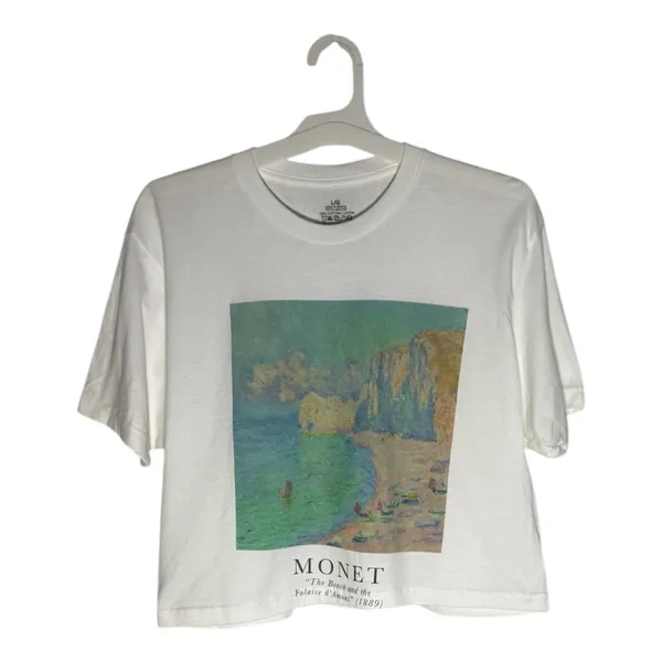 NWOT Monet Art Crop T Shirt White Graphic Tee The Beach Falaise d’Amont This NWOT Monet Art Crop T Shirt in white features a graphic design inspired by The Beach Falaise d’Amont 1889, making it a stylish and artistic addition to any woman's wardrobe. Made from 100% cotton, this regular fit tee has a crew neckline and a cropped style for a modern and trendy look. Perfect for art enthusiasts or those looking to add a unique touch to their outfit, this T-shirt is comfortable and versatile, ideal for everyday wear. - Image 10