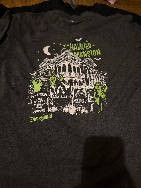 Explore the eerie allure of the Haunted Mansion with this Disney tee. Features a striking graphic in charcoal and neon green. Ideal for theme park enthusiasts. - Image 4