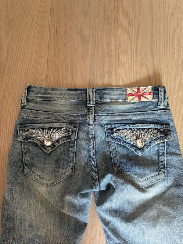 Machine distressed crystal embellished low rise denim jeans - Image 10
