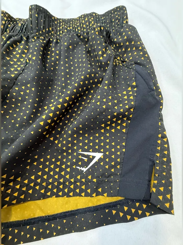 Gymshark Black Shorts with Gold Triangle Print - Image 2
