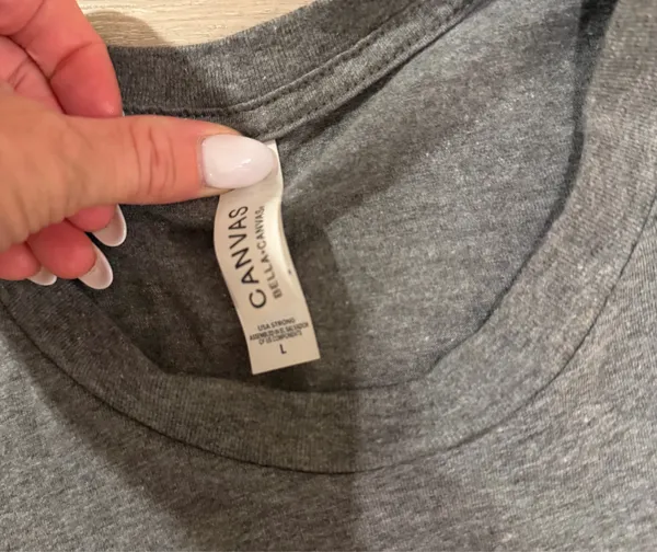 Cooper Alan Graphic Tee Heather Gray Women's Size Large Add this fan-favorite Cooper Alan graphic t-shirt to your collection! This official merchandise features the iconic "CA" logo in a circular crest on the chest, printed on a premium Bella + Canvas heather gray tee. Crafted for comfort, it has a classic crew neck and short sleeves, making it perfect for concerts or everyday wear. • Size: Large • Condition: Excellent pre-owned condition—worn but shows no flaws and is in perfect shape. • Brand: Bella + Canvas (Cooper Alan Merch) • Material: Soft, breathable cotton-poly blend. - Image 3