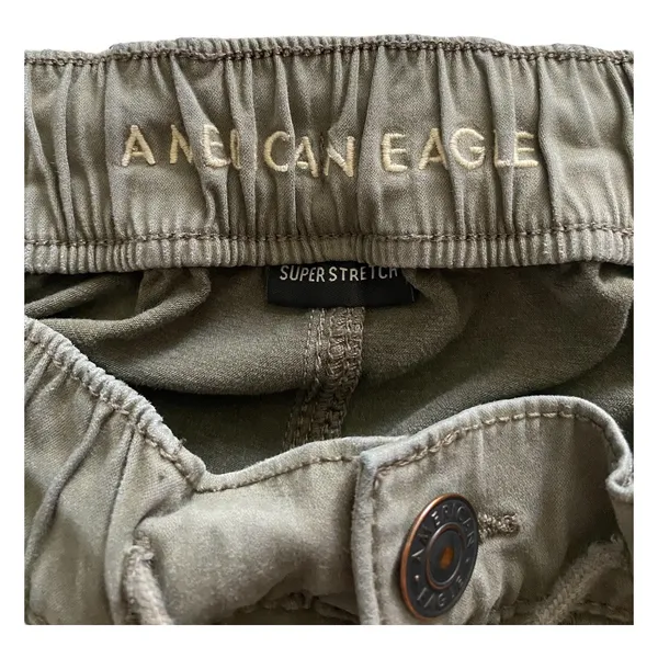 American Eagle -ARMY GREEN JOGGER PANTS-SIZE 2 Elastic waist with drawstring, zip front, two front and two back pockets, elastic ankles with a side zipper, excellent condition Measurements: Waist: side to side 13-16 inches Rise: 9 inches Inseam: 37 inches - Image 11