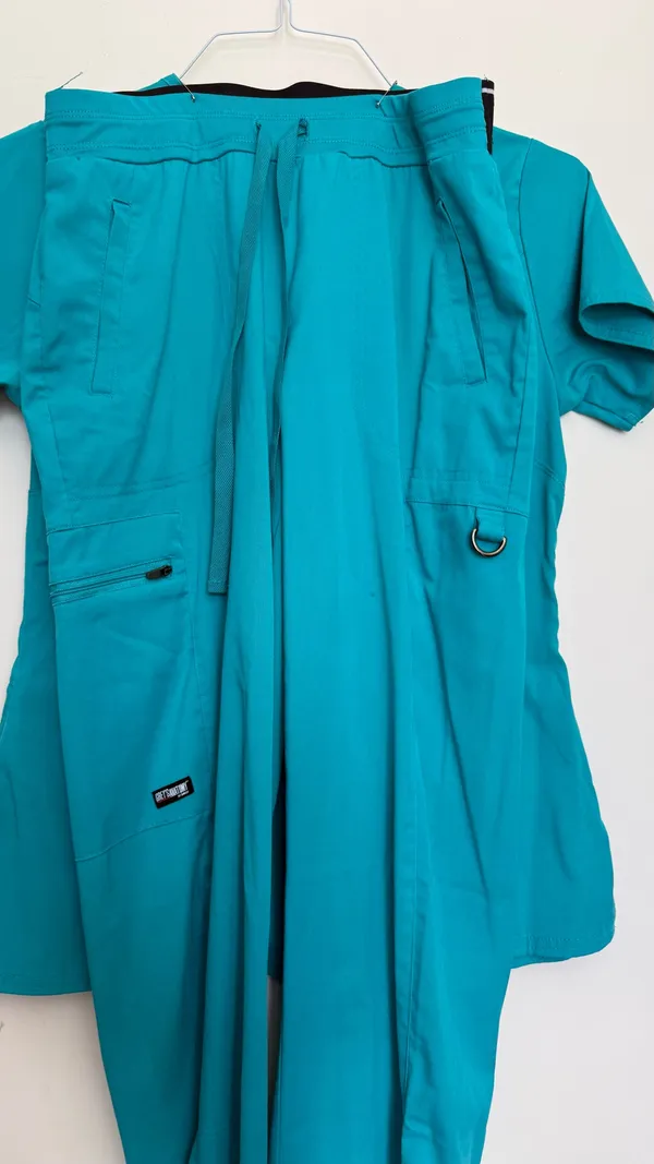 Stylish turquoise scrub ensemble from Grey's Anatomy. Features a V-neck top and matching pants. - Image 5