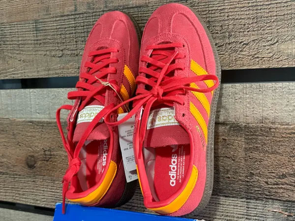 Adidas handball poles in a pretty red with light orange stripes - Image 3