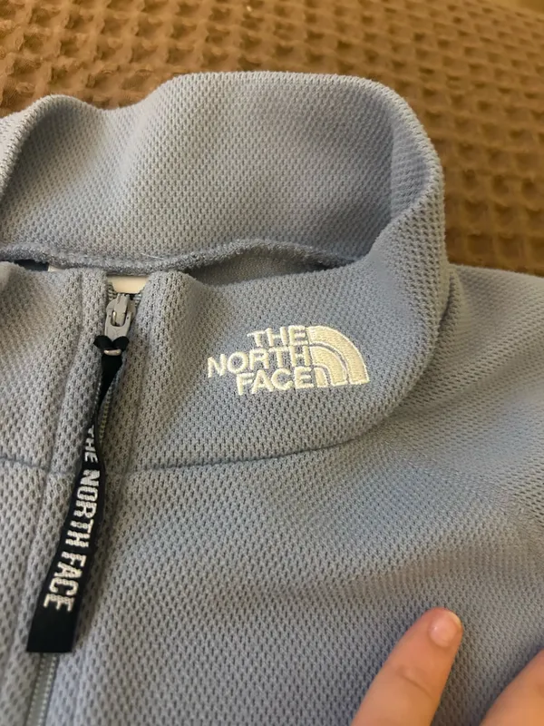 light blue north face woman’s quarter zip turtle neck vest in a size L - Image 2