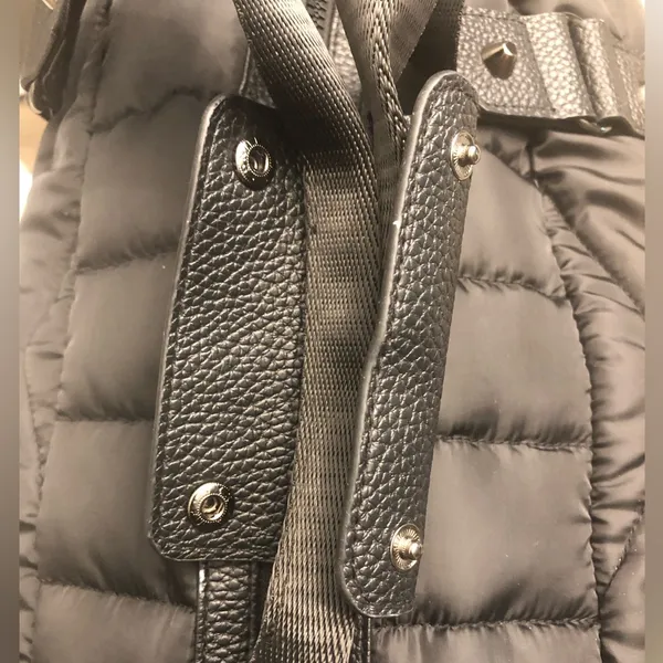 Cynthia Rowley Anthropologie’s Quilted Puffer Travel Bag is a stylish and functional accessory designed for travel enthusiasts. Crafted from high-quality materials, this bag features a quilted exterior for added texture and durability. Its spacious interior provides ample room for belongings, while the thoughtful design includes convenient pockets for organization. The soft puffer style adds a chic touch, making it suitable for various occasions, whether heading to the gym or embarking on a weekend getaway. With comfortable straps for easy carrying, this travel bag combines practicality with fashionable flair. - Image 6