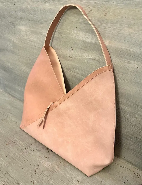 Hobo pink and tan shoulder bag with a unique asymmetrical design, featuring a side zipper closure - Image 2