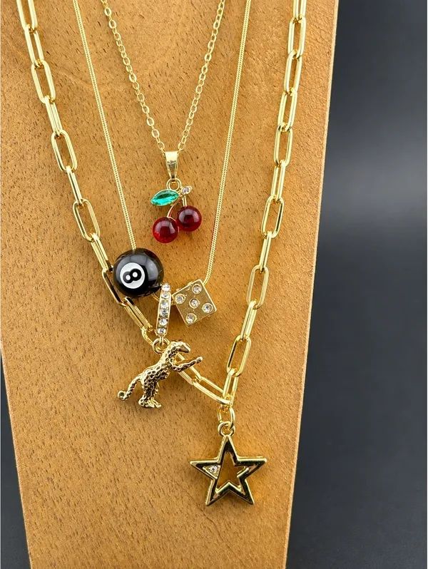 Set of 3 Gold Tone Charm Necklaces with Star, Dinosaur, Dice - Image 2