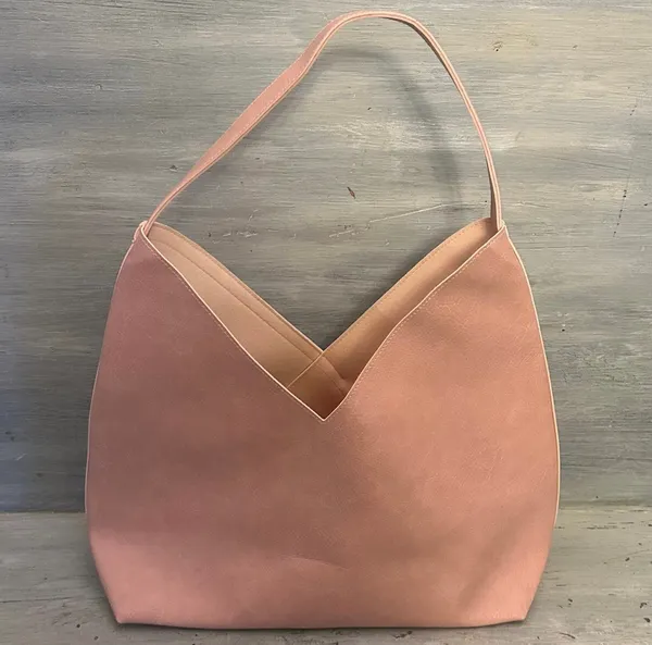 Hobo pink and tan shoulder bag with a unique asymmetrical design, featuring a side zipper closure - Image 4