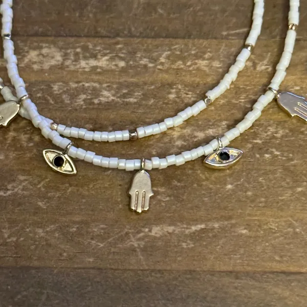 White beaded bolo bracelet with hamsa and evil eye charms - Image 4