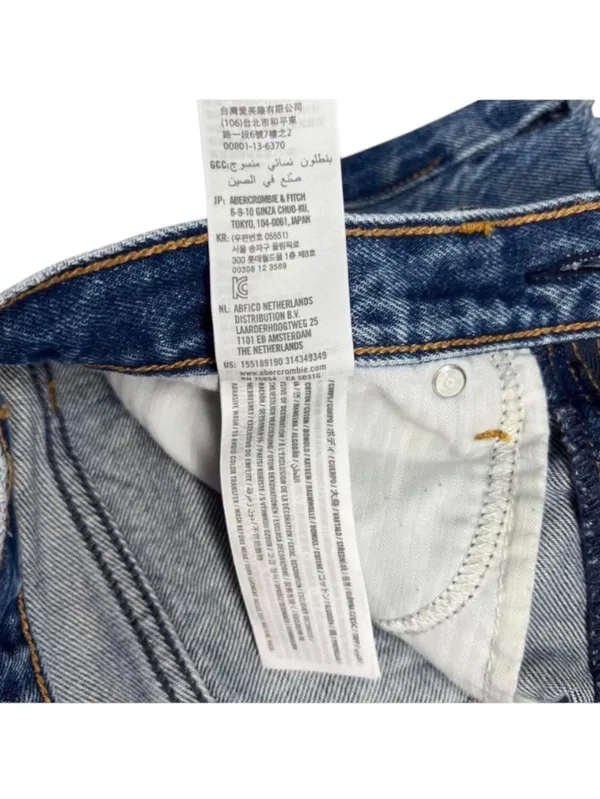 Abercrombie & Fitch Mom Cutoff High Rise Denim Shorts Womens 27 Abercrombie & Fitch high rise cutoff mom shorts in a distressed medium wash. Raw frayed hemline with classic 5 pocket styling and zip fly button closure. Modern release design features a clean back waist without traditional leather logo patch. Rigid 100 percent cotton denim build with structured vintage silhouette. Excellent preowned. No flaws, stains, or unintentional tears. Measurements Flat Lay: Waist 14.25 in Rise 10 in Inseam 2 in Hips 17 in - Image 5