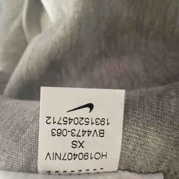 Nike Gray Minimalist Hoodie XS Y2K Athleisure Streetwear Description: Soft gray Nike hoodie with embroidered logo and kangaroo pocket. Perfect minimalist, gorpcore, streetwear, gym, and casual layering essential. Pre-owned Condition: Excellent Flaws: No significant flaws observed. Stored: Model created by AI. NikeHoodie Streetwear Athleisure MinimalistStyle Gorpcore HeatherGray Pullover LogoHoodie Layering Y2K - Image 8