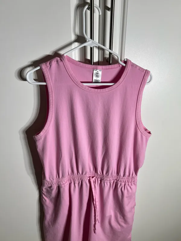 Soft pink sleeveless one-piece with an adjustable drawstring waist for a comfortable fit, with pockets. Lightweight cotton-blend fabric designed for easy movement. Simple, versatile style that pairs well with sneakers or sandals. Member’s mark size large. 57% cotton, 38% polyester, 5% spandex - Image 2