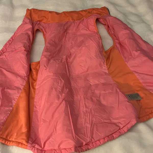 a Tangerine women's puffer vest in pink with orange side panels. Size large - Image 8