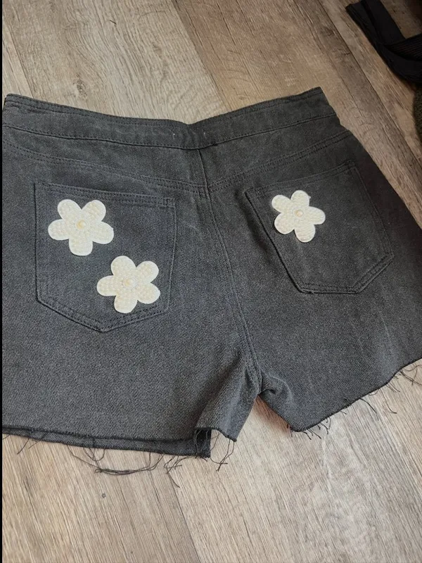 POL black denim skort features distinctive pearl-embellished flower details - Image 8
