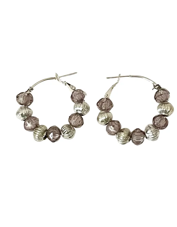 These handmade beaded hoop earrings feature a unique combination of purple, gray, and silver tones. The faceted beads add a touch of bohemian style, making them a perfect gift for someone who loves one-of-a-kind accessories. The handmade quality adds a personal touch to these earrings, making them a standout piece for any jewelry collection. - Image 3