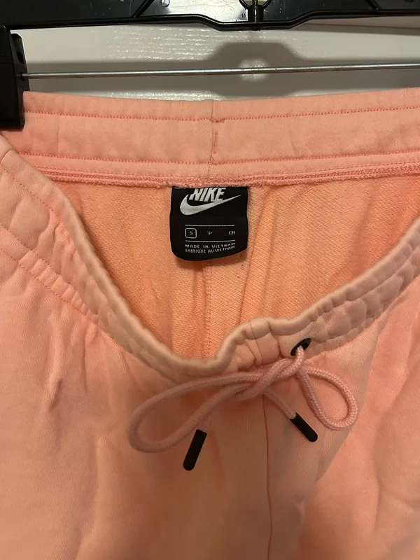 NIKE size small Soft fleece joggers in a warm peach-coral shade. Elastic waistband with adjustable drawstring. Tapered legs with cuffed ankles. Embroidered Nike logo at hip. Cozy everyday women small brand new - Image 8