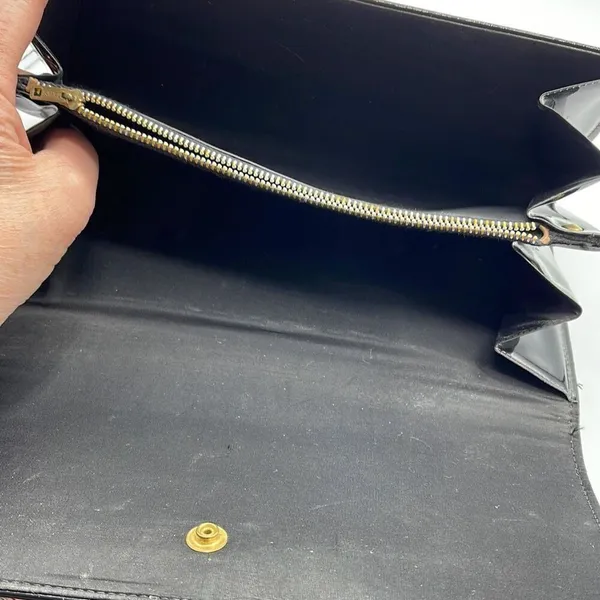 Black faux patent leather clutch with wave design on front. - Image 6