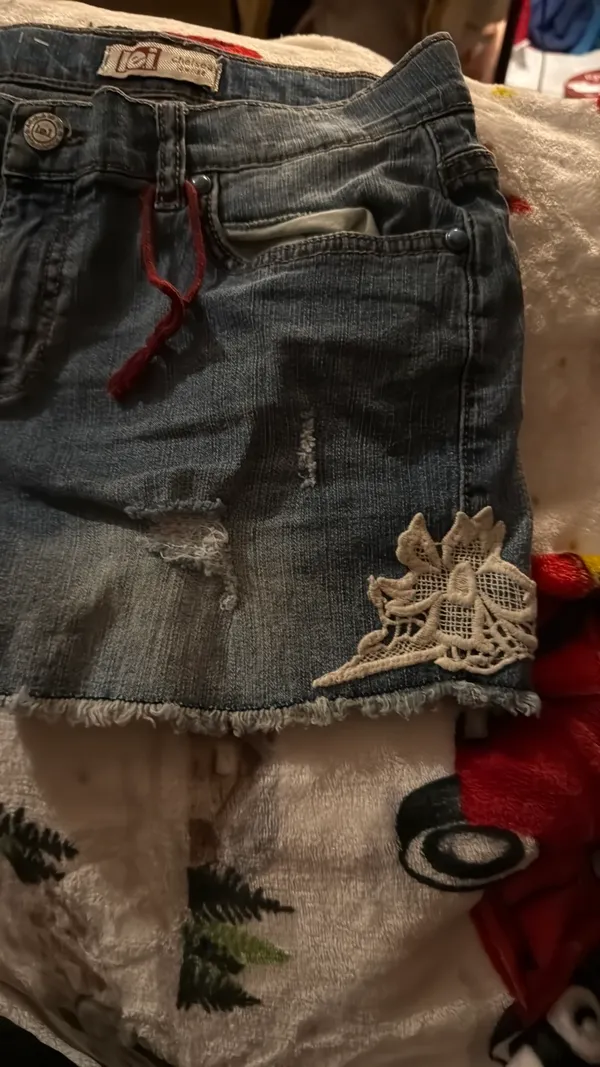 Stylish blue denim shorts with a trendy distressed look. Perfect for casual outings. - Image 2