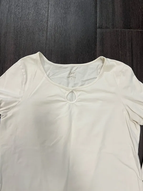 Soft cream long sleeve top with a modest scoop neckline. Features a small decorative ring keyhole at center front. Lightweight, easy to layer for casual or office wear. Simple, clean silhouette for versatile styling. J, Jill size medium. 95% cotton 5% spandex - Image 2