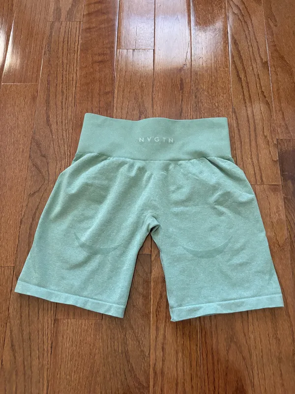 NVGTN Sage Green Contour Seamless Shorts M bike shorts lightly worn Our signature seamless material is now available in shorts! These shorts feature a conservative length that won’t be interrupted through movement along with a form flattering waistband that offers slight compression. This buttery soft and breathable material will not only feel weightless on your body, but will move with and not against you. Pair these with its matching seamless top or bra to complete the look. - Nylon and spandex - Fabric feels… lightweight, soft, stretchy - High waisted - Compressive waistband contour shaping - Image 4