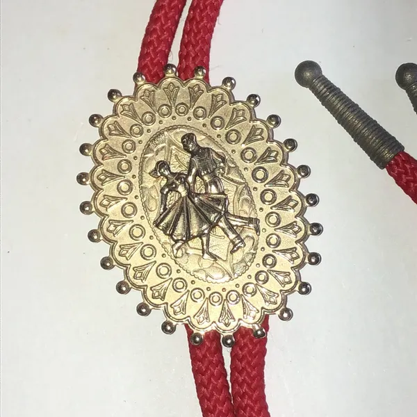 Red Western Bolo Tie with Decorative Gold Tone Dancer Medallion - Image 3
