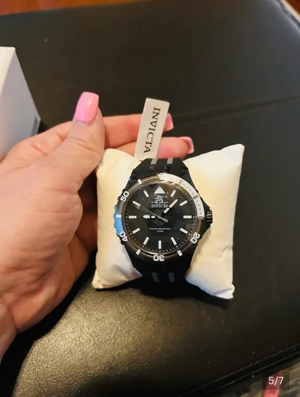 Sporty Invicta men's watch with bold black dial. High-contrast white markers and hands for easy reading. Durable black strap with white stripe accents. Water resistant design for active use. This watch is OUT OF STOCK ONLINE but here’s one for you! The: 69447 - This beautiful Invicta Subaqua watch contains a precise Quartz movement in addition to a black case. Its face displays a black, plastic dial protected by a highly resistant Flame Fusion Crystal. This timepiece is completed by a black, band and it offers water resistance of up to 100 m. Led with expert engineering, no feat or occasion will ever be too great for Invicta's Subaqua to handle. - Image 4