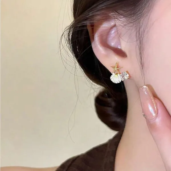 Gold and White Starfish Shell Earrings - Image 3