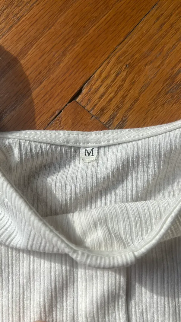 A white t with buttons going down Size M - Image 3