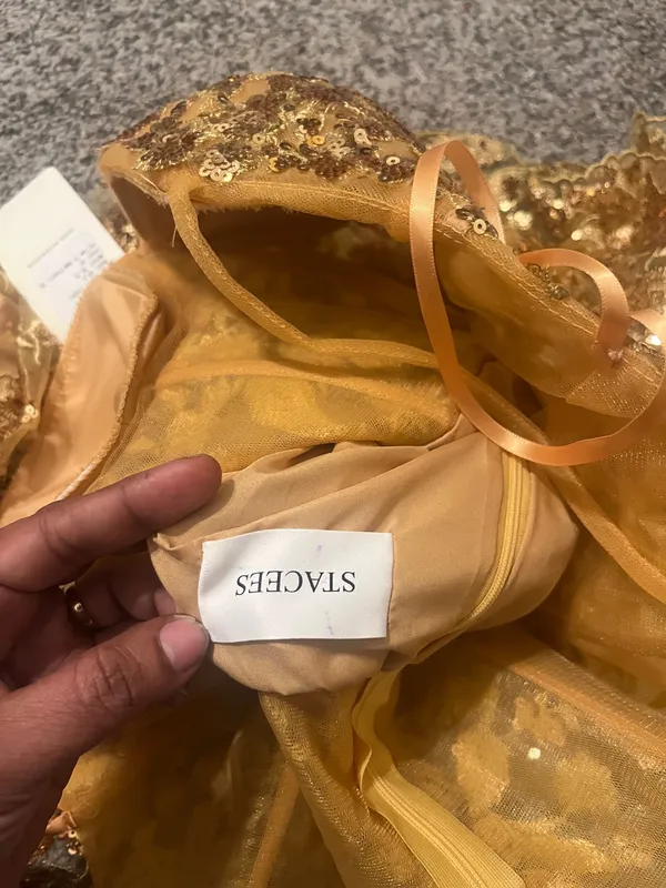 Stacees Shine in this elegant gold lace dress, perfect for any special occasion. The intricate lace detailing adds a touch of sophistication. - Image 8