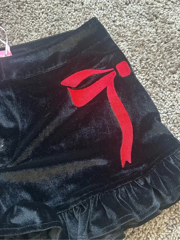 Sugar Thrillz Black Velvet Ruffle Shorts with Red Bow Accents - Image 3