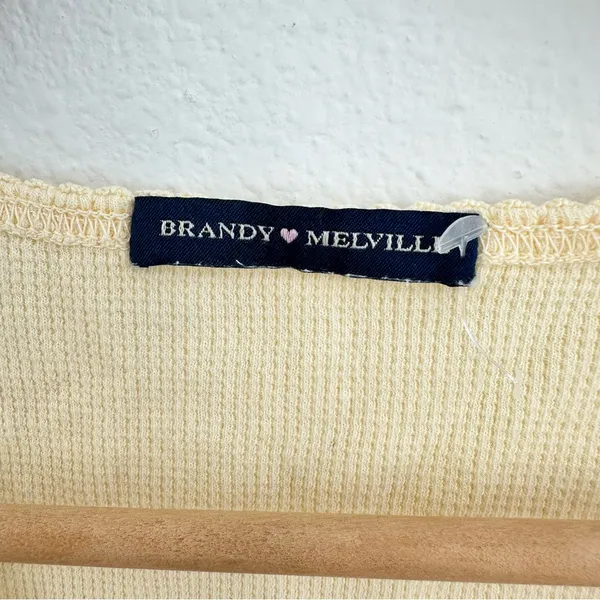 yellow Brandy Melville tee with a cute criss-cross detail - Image 2