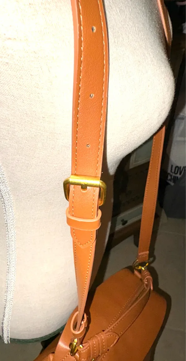 The Free Assembly brown bag features a faux leather structure with top handles and a removable crossbody strap. - Image 2