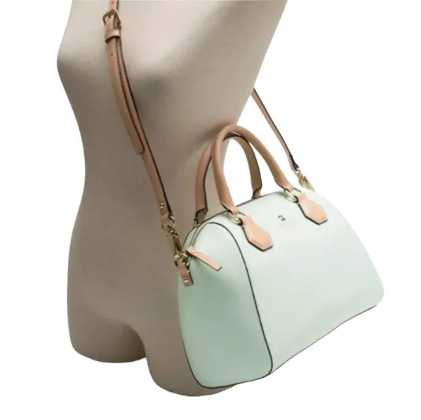 Kate Spade NEW YORK-MINT MOJITO PIPPA PARNELL STREET LEATHER SATCHEL Perfect spring bag, mint green white tan handle and crossbody strap, top zip closure, stripe print interior, inside zip pocket, inside two open pockets, amazing condition, there are two call outs, a small smudge on the bottom of the bag and a small smudge on one corner, please see the last two pictures **This bag is preowned and is being sold as is** - Image 4