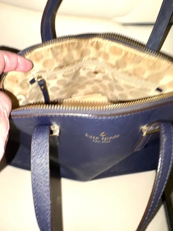 This bag is a Kate Spade Cedar Street Maise satchel in navy blue with gold-tone hardware, made of Saffiano leather, with a top zip closure and top handles. - Image 3