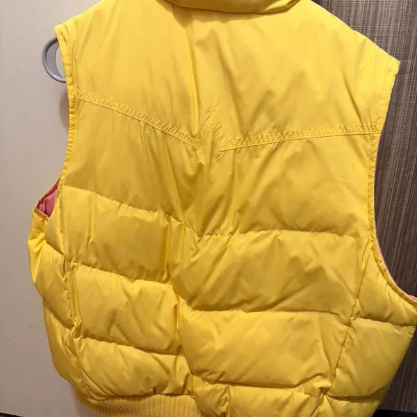 bright yellow Gap puffer vest with a contrasting pink lining and snap button closures - Image 3