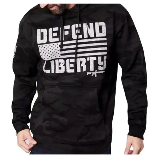 Howitzer "Defend Liberty" Black Camo Hoodie Elevate your casual wear with this rugged and patriotic Howitzer "Defend Liberty" Hoodie. Featuring a stealthy black multicam (camo) pattern, this hoodie is designed for those who value both style and a strong message of freedom. Constructed with high-quality, durable fabric, it offers a comfortable fit perfect for outdoor adventures, range days, or daily wear. Product Features: • Brand: Howitzer Manufacturing Co. • Design: Bold "DEFEND LIBERTY" distressed graphic with the American flag and an AR-15 silhouette on the front. • Back Detail: A vertical "DEFEND LIBERTY" spine graphic for a unique look from every angle. • Sleeve Detail: Features the Howitzer brand American flag patch on the sleeve. • Pattern: Modern black/dark grey camouflage. • Style: Pullover with adjustable drawstring hood and a spacious kangaroo front pocket. - Image 3