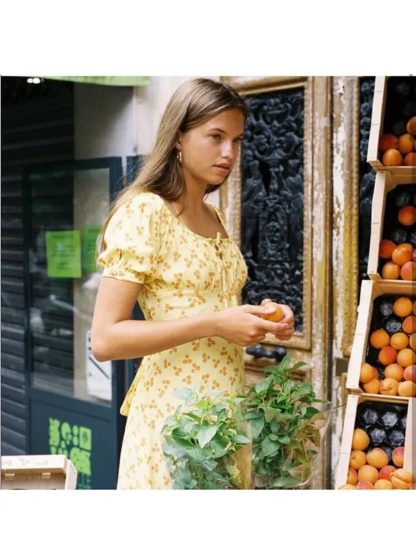 With Jéan Loretta Dress in a yellow multi-color print - Image 2