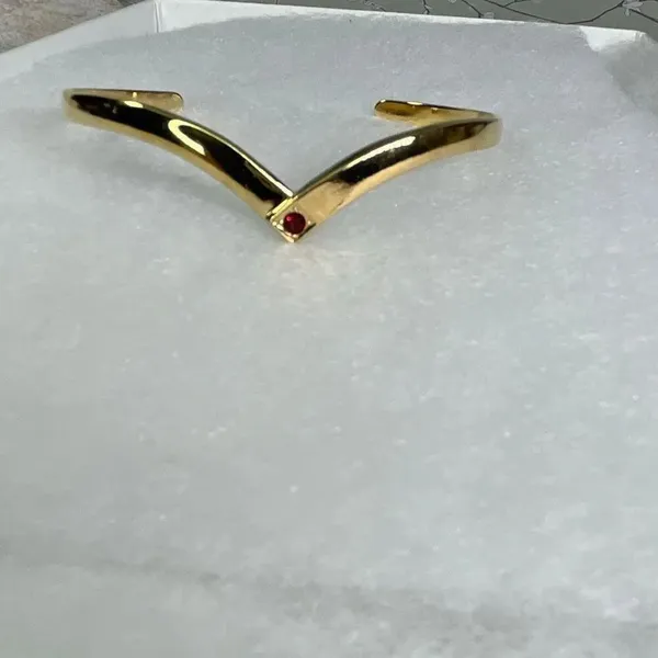 Avon gold tone V shaped cuff bracelet with faux ruby or garnet. Large - Image 2